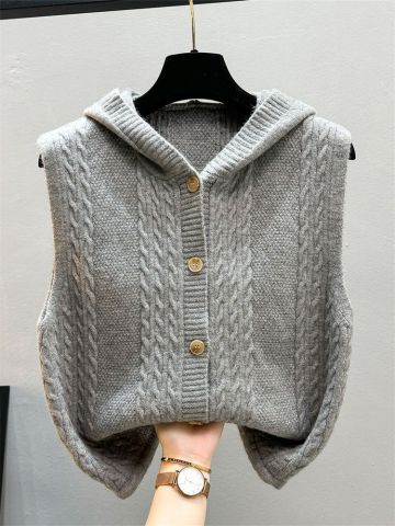 Beige knitted women's vest with toggle closures, textured twist pattern, elegant layering waistcoat
