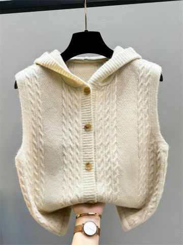Beige knitted women's vest with twist waistcoat design, toggle closures, and warm textured layering