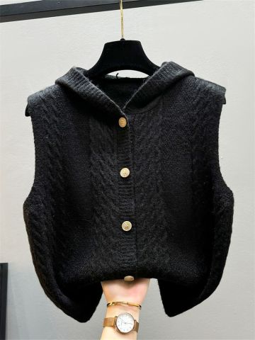 Beige knitted women's vest with toggle closures, soft textured twist pattern for elegant layering