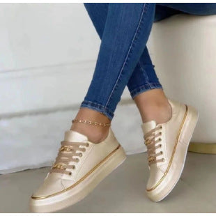 Women's white leather lace-up low-top sneakers with classic silhouette and premium polished finish