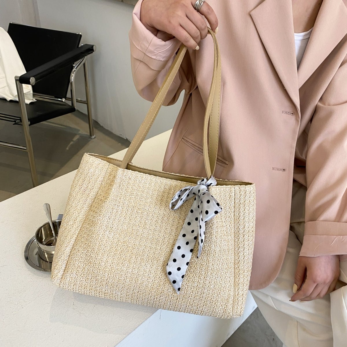 Natural straw woven handbag with leather strap, medium tote silhouette and spacious boho summer interior