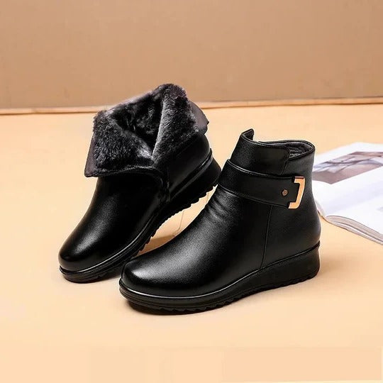Women's black mid-calf structured boots with side zip, stitched panels, and enclosed coverage silhouette