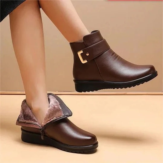 Women's black mid-calf structured boots with side zip, stitched panels, and enclosed coverage silhouette