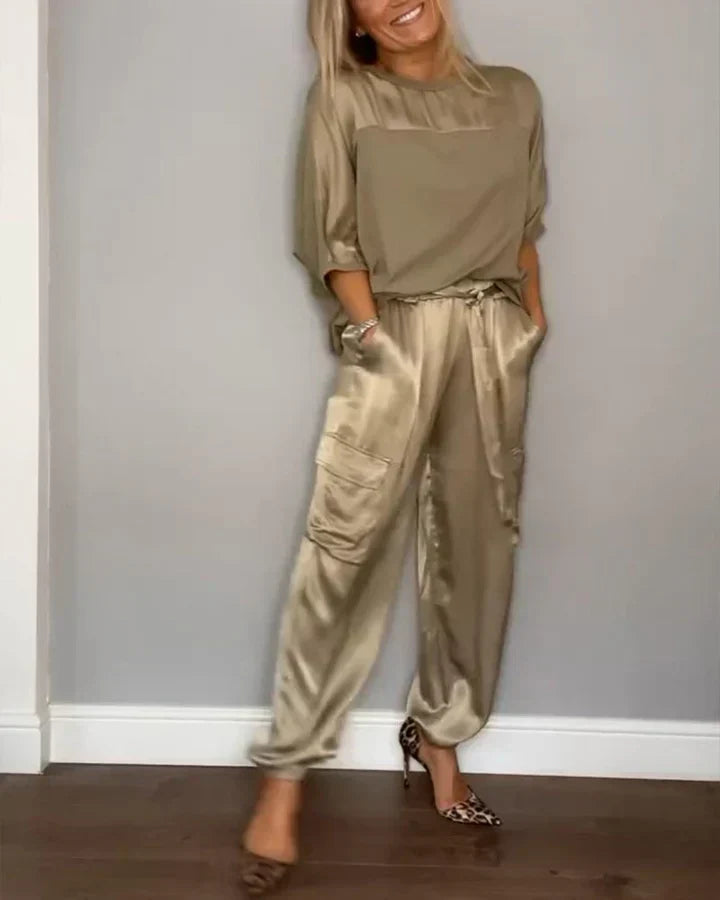 Women's ivory satin lounge set with flowing sleeves and tailored wide-leg pants, luxurious fit