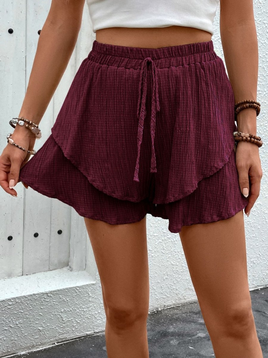 Women's beige high waist layered shorts with tied front skirt illusion, chic summer beachwear