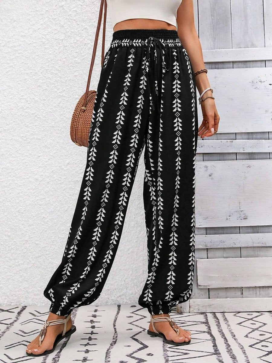 Bold printed high waist pants with tied waist detail, figure-flattering silhouette for creative style