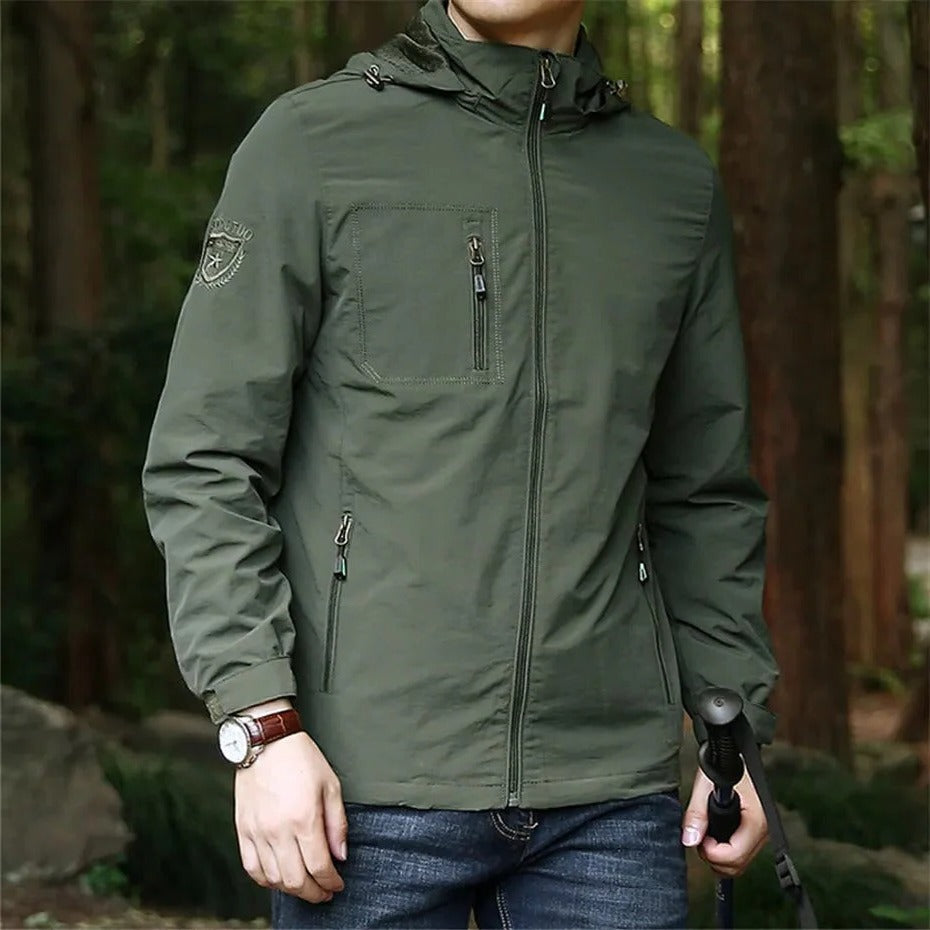 Lightweight weatherproof olive green adventure jacket with hood, slim trail-ready cut for outdoor enthusiasts