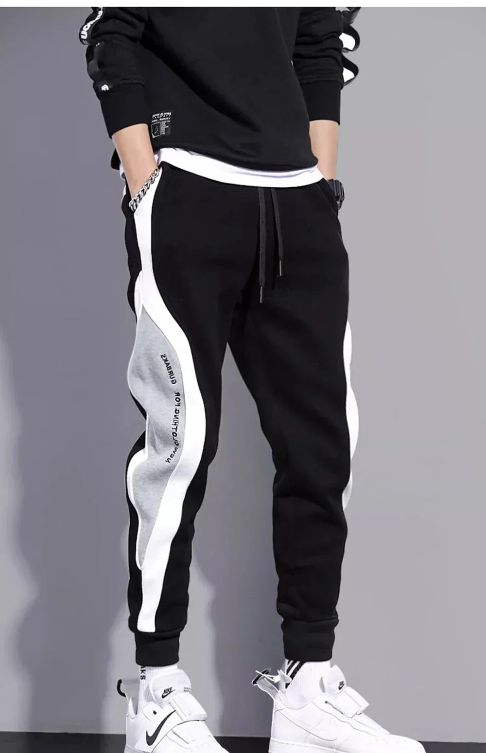 Men's loose fit gray sports pants with patchwork side panels, relaxed athletic cut for spring