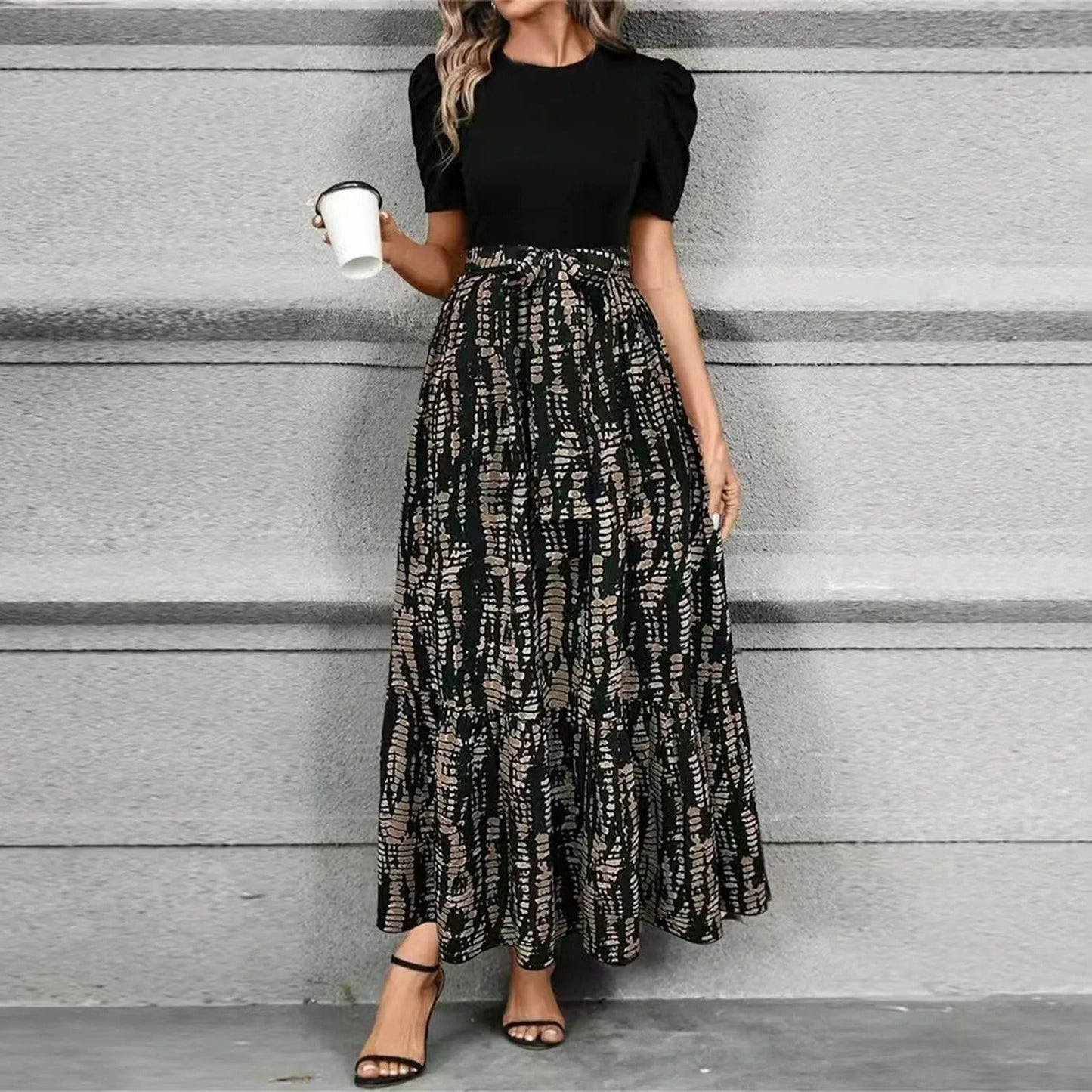 Black floral maxi dress with high waist tie-front bow, bold botanical print, feminine silhouette