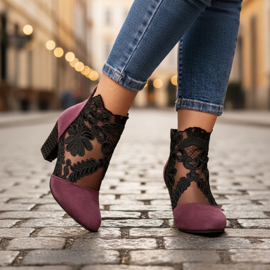 Women's black high heel ankle boots with delicate lace details and elegant pointed toe silhouette