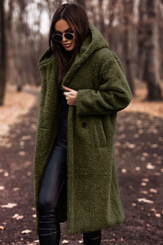 Insulated mid-length winter coat with high collar, belted waist, and button-front closure for cold weather