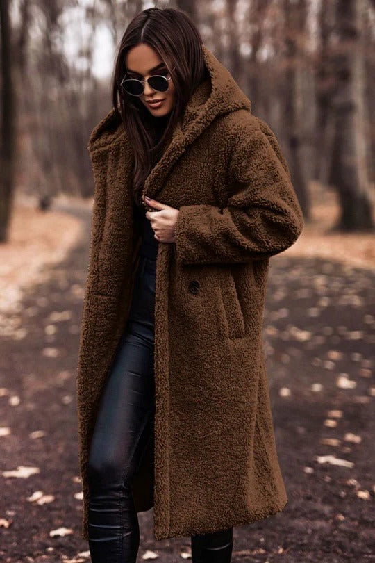 Women's insulated mid-length winter coat with high collar, belted waist, and button-front closure