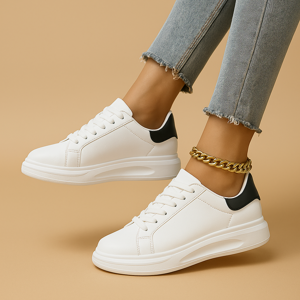 Women's minimal white sneakers with cushioned sole, clean stitched paneling, and lightweight lace-up design