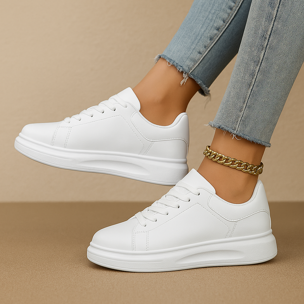Women's minimal white sneakers with cushioned sole, clean stitched paneling and lace-up closure