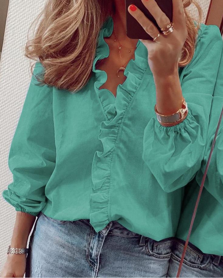 Women's white ruffled V-neck blouse with romantic chic fit and elegant cascading ruffle detail