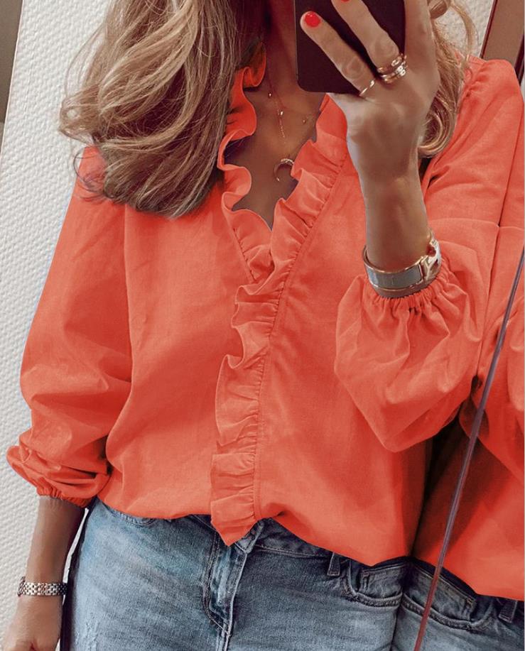Women's ivory ruffled V-neck blouse with romantic flutter detail and flattering office-ready silhouette