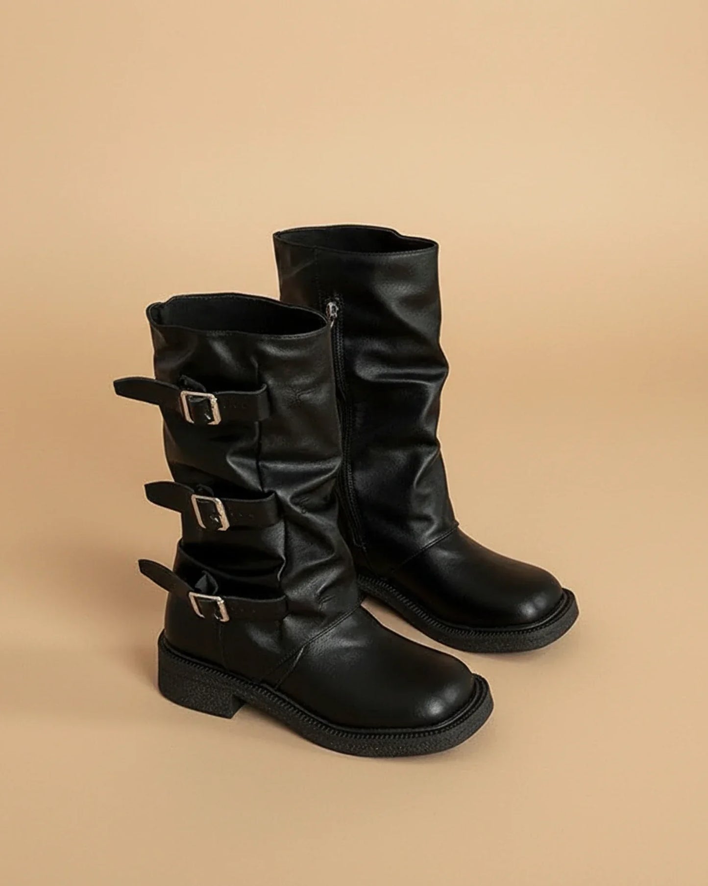 Women's black mid-calf slouchy buckle boots with bold platform lug sole and edgy silhouette