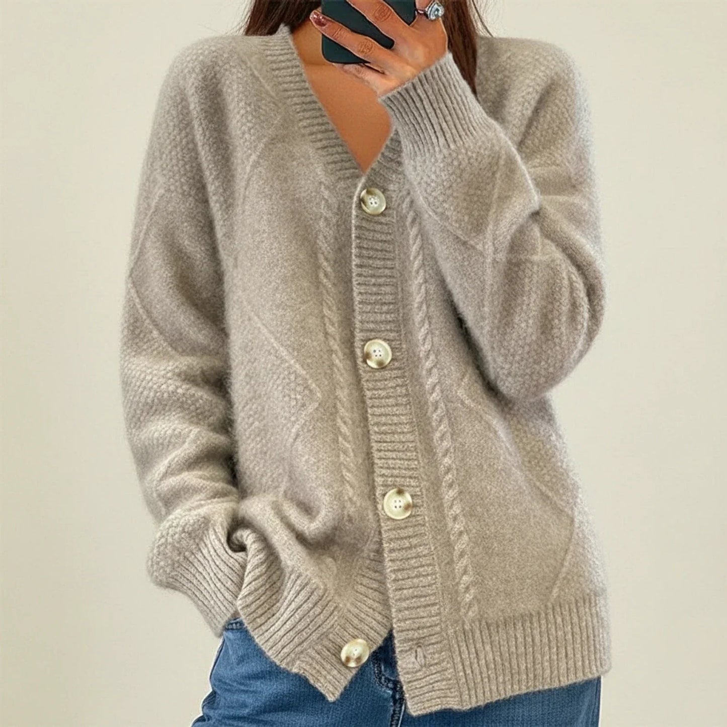 Women's cable knit cardigan, button-front V-neck silhouette in neutral tone for versatile layering