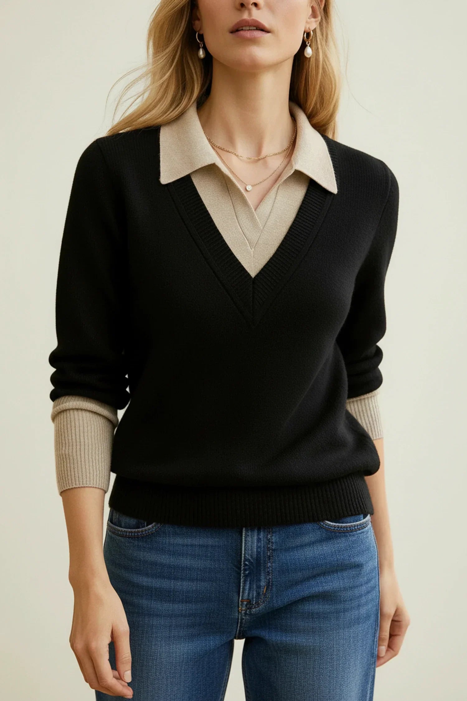 Women's navy v-neck collared sweater with button cuff details, polished office-ready layered look