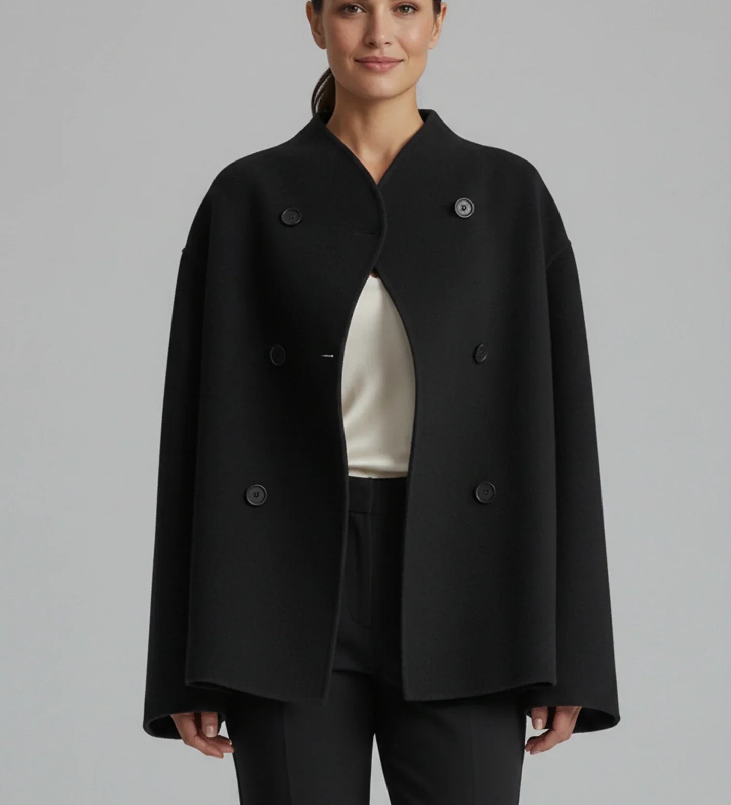 Women's collarless double-breasted boxy coat in neutral tone, cropped length, modern oversized silhouette