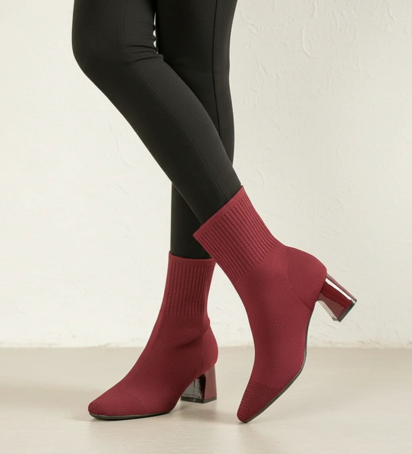 Women's black sock-knit ankle boots with block heel, stretchy form-fitting upper for sleek silhouette