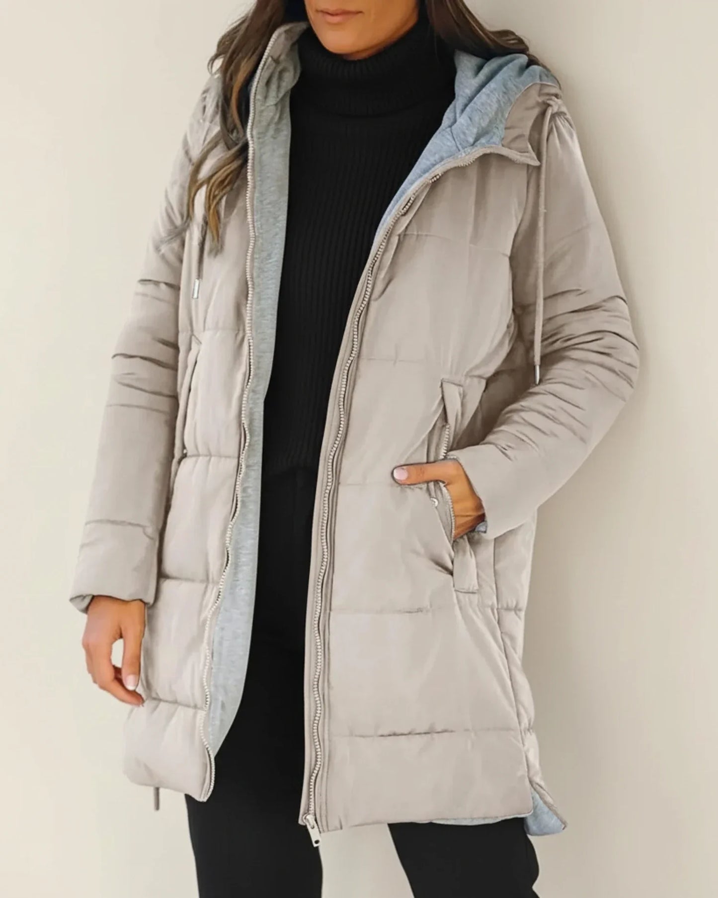 Women's long quilted hooded puffer winter jacket mid-length silhouette with front zip closure