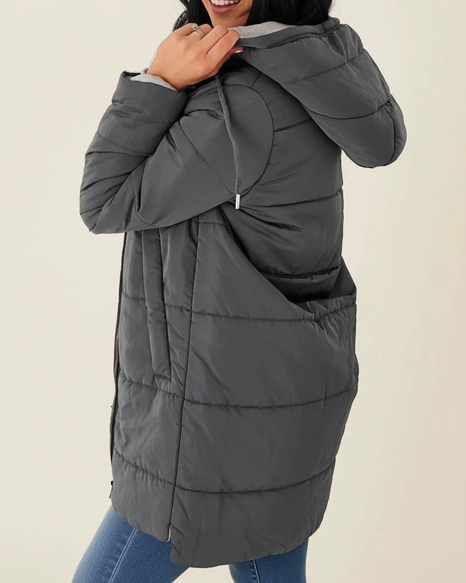 Women's long quilted hooded puffer jacket mid-length silhouette with front zip closure for winter warmth