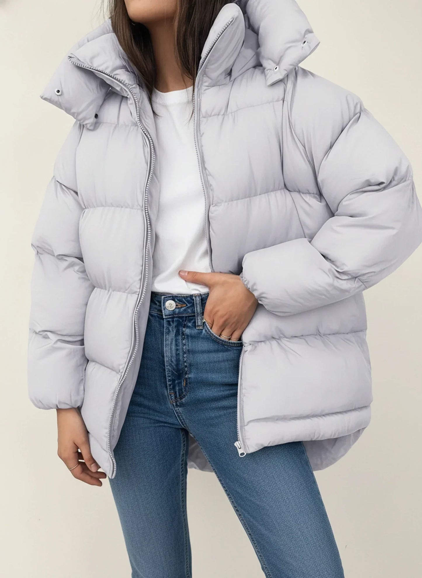 Women's oversized hooded puffer jacket in hip-length silhouette for winter warmth and modern style