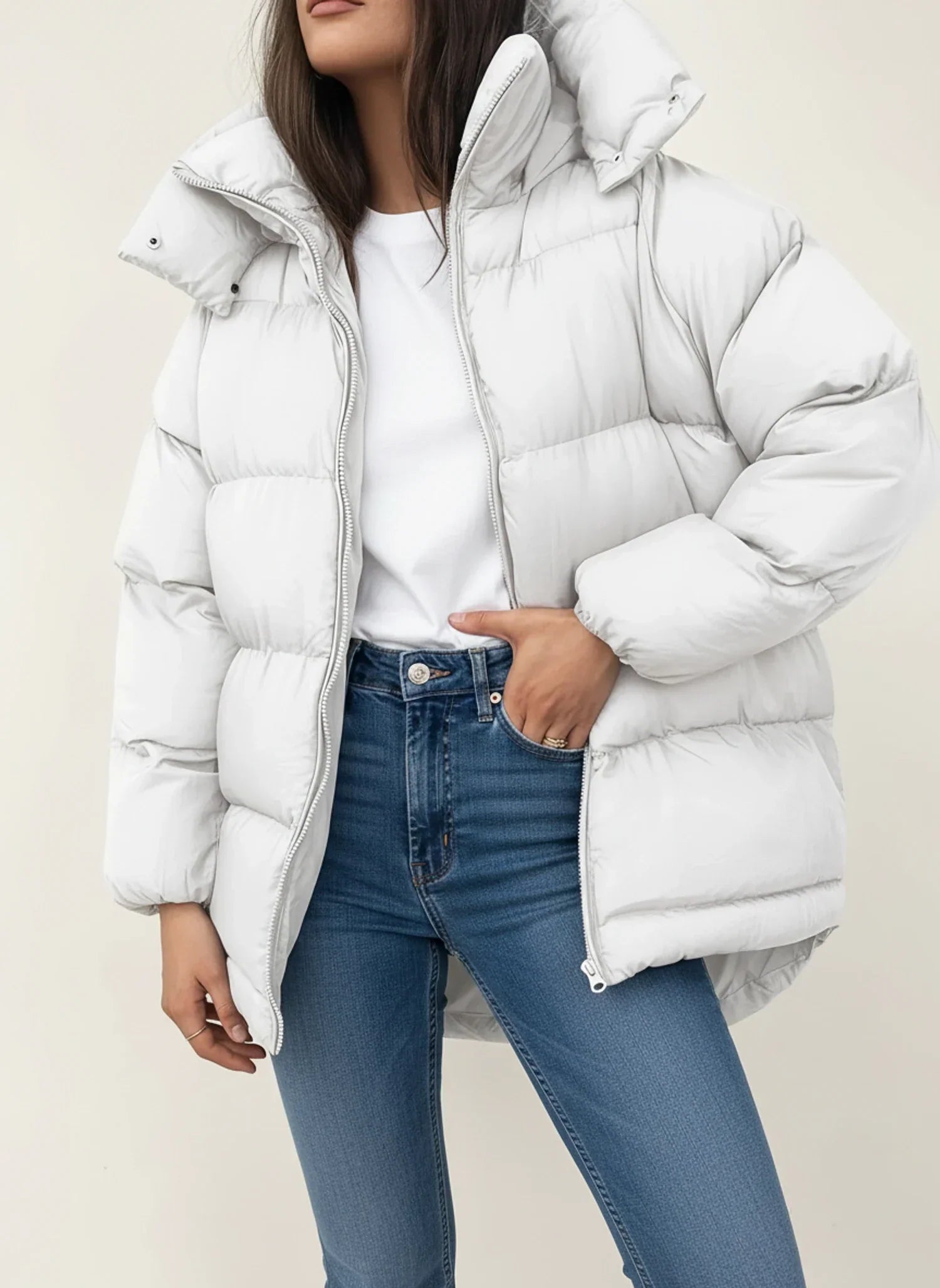 Women's oversized hooded puffer jacket in neutral tone, hip-length winter coat with modern silhouette
