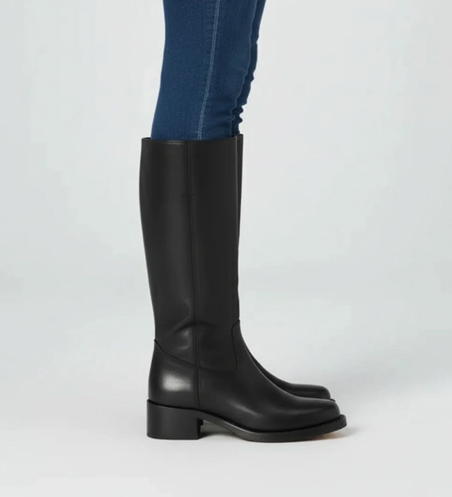 Women's black faux leather knee-high boots block heel Western-inspired classic silhouette