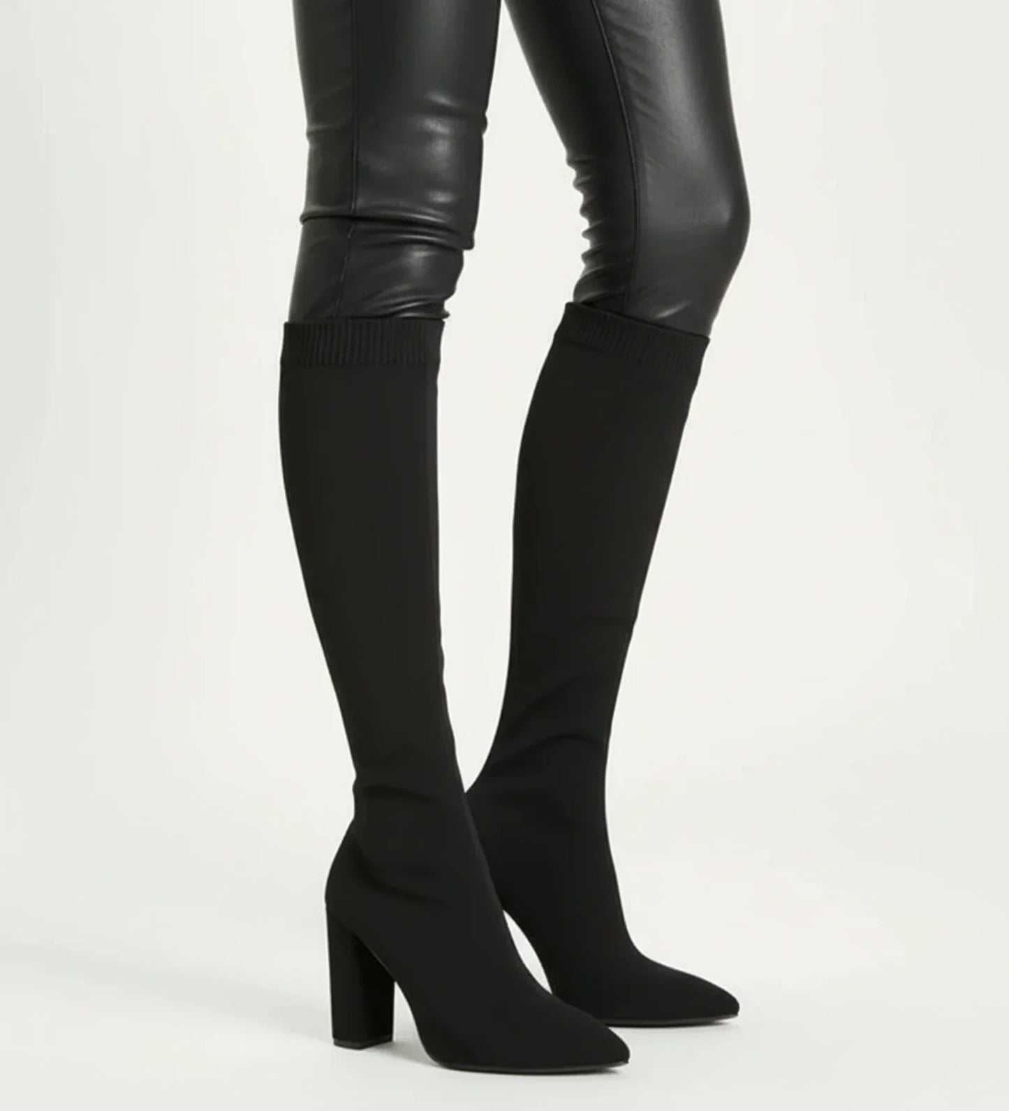 Women's black knit knee-high block heel boots with pointed toe pull-on sock style