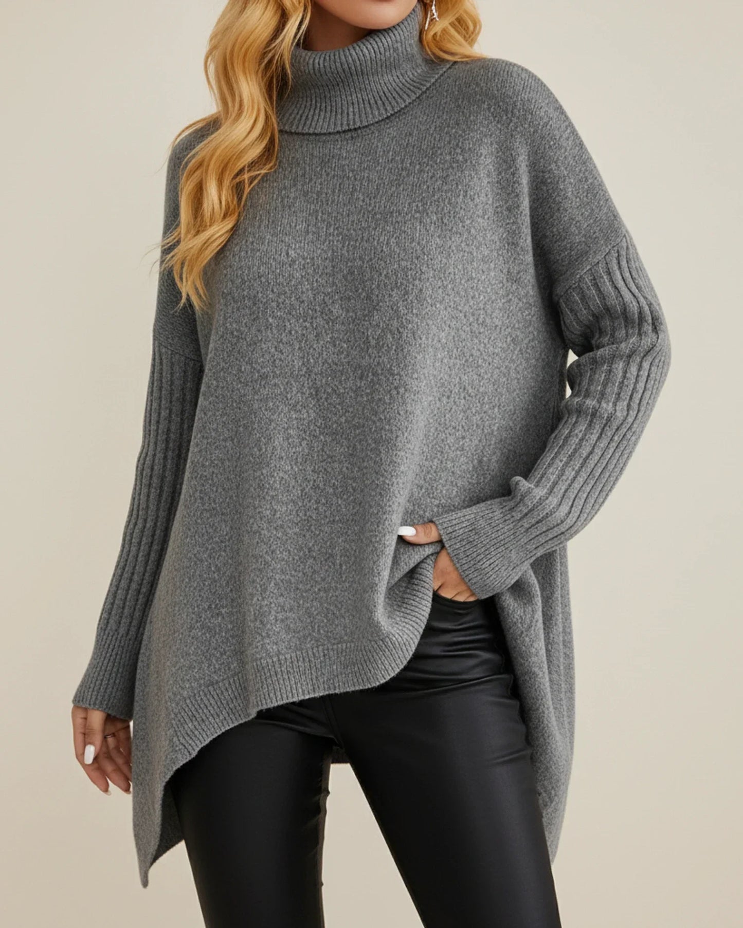 Women's oversized ribbed knit turtleneck sweater with asymmetric hem, cozy winter layering style