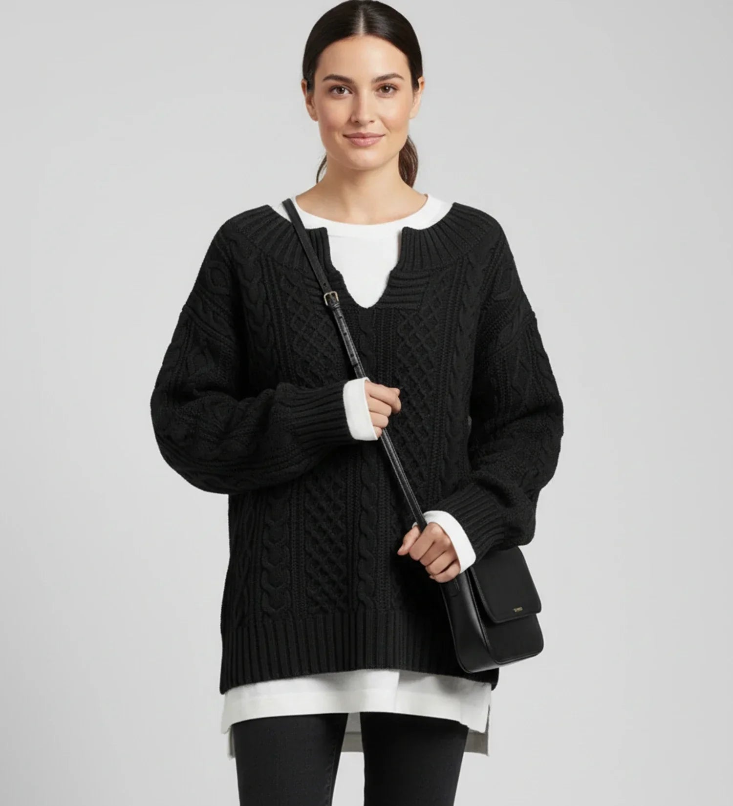 Women's oversized cable knit V-neck sweater in cozy relaxed fit with intricate textured pattern