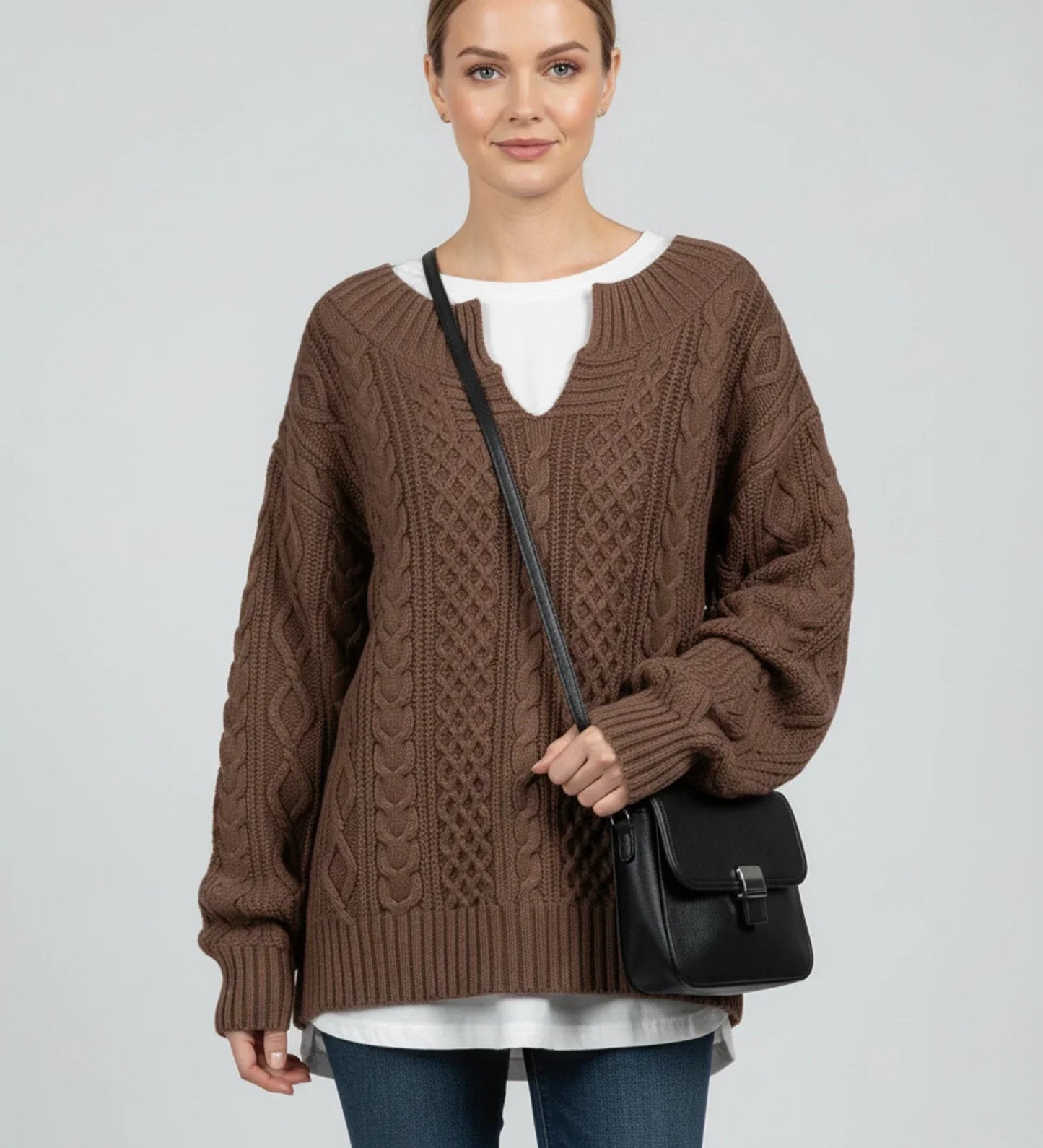 Women's oversized cable knit V-neck sweater in cozy relaxed fit with intricate textured knit pattern