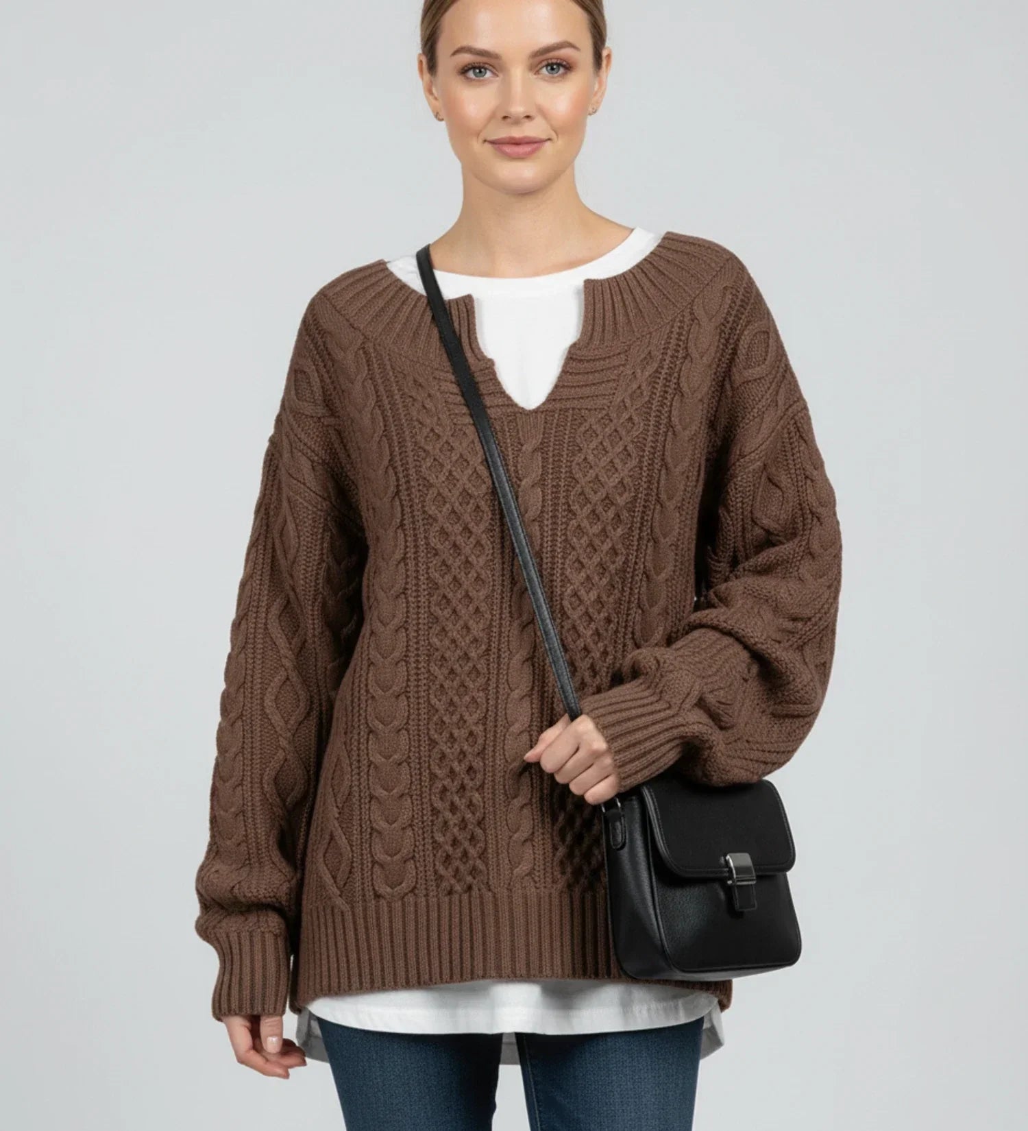 Women's oversized cable knit V-neck sweater in cozy relaxed fit with intricate textured knit pattern