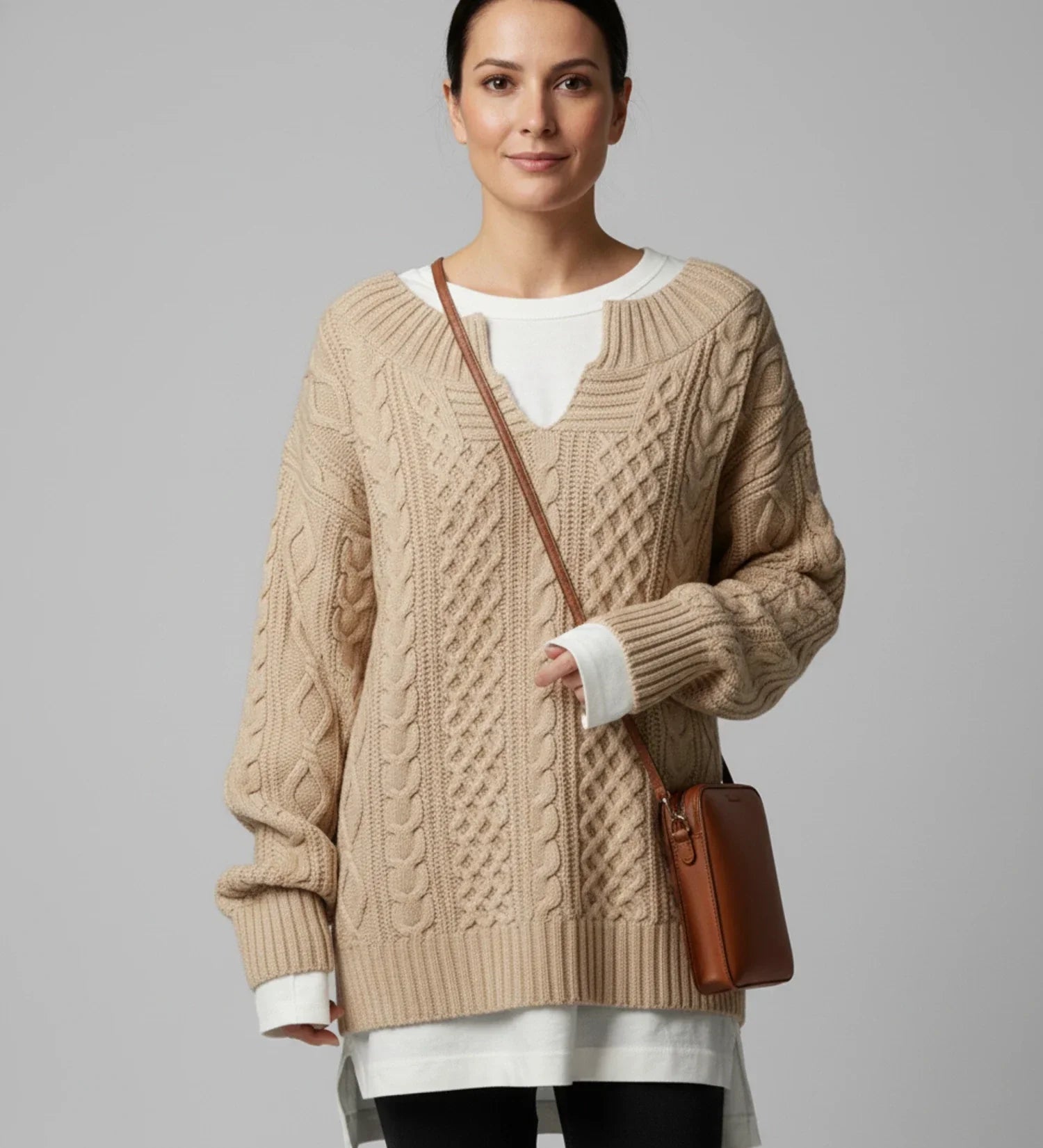 Women's oversized cable knit V-neck sweater in a cozy relaxed fit with intricate textured pattern