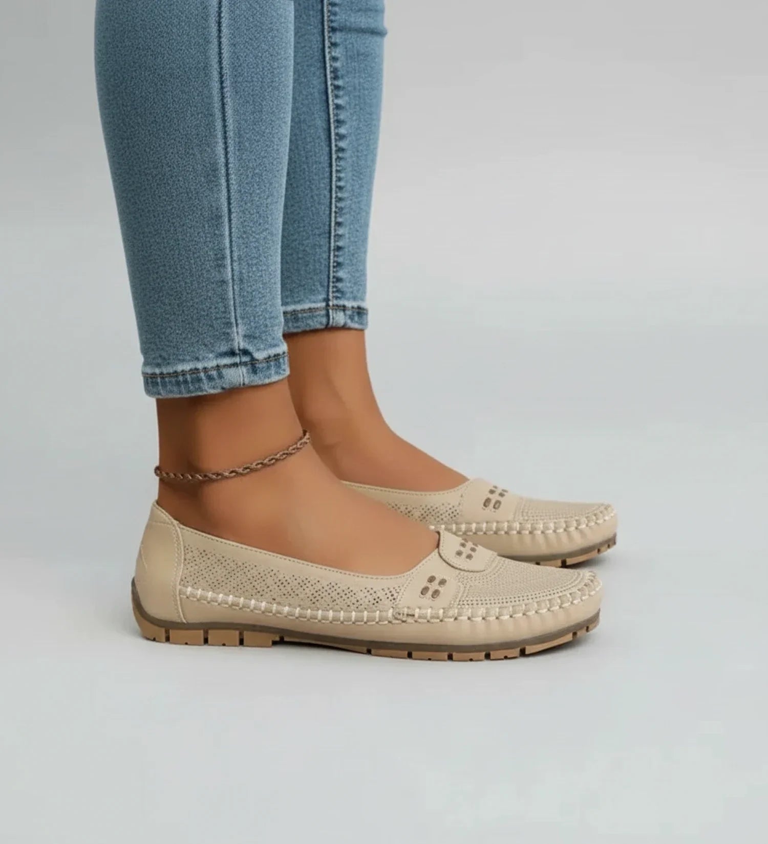 Women's black perforated slip-on loafers with round toe, breathable design for all-day comfort