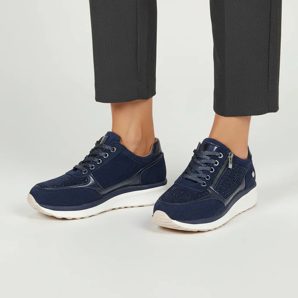 Women's white platform sneakers with side zip closure, chunky sole, casual street-ready silhouette