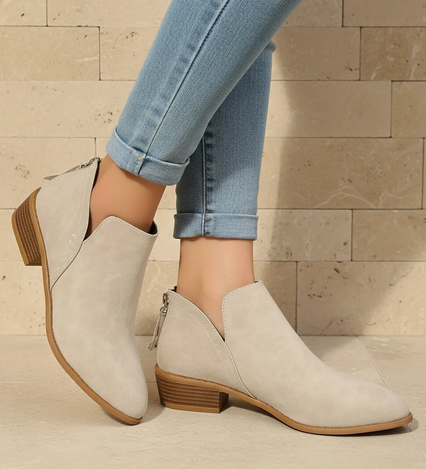 Women's black pointed toe ankle boots with V-cutout detail and low block heel for versatile style