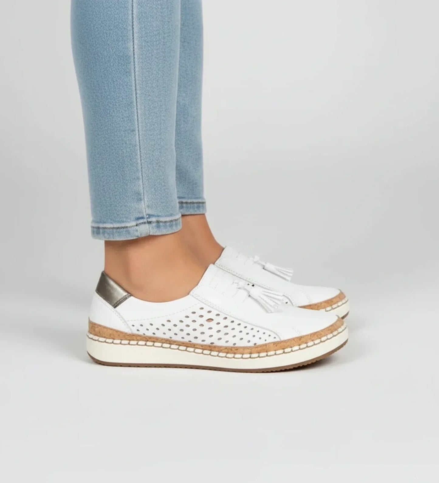 Women's slip-on perforated tassel loafer sneaker in neutral tones with breathable upper and laceless design