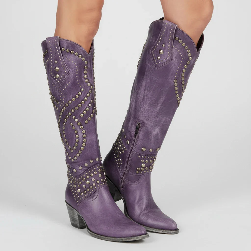 Women's brown studded knee-high western boots with block heel and bold cowgirl embellishments