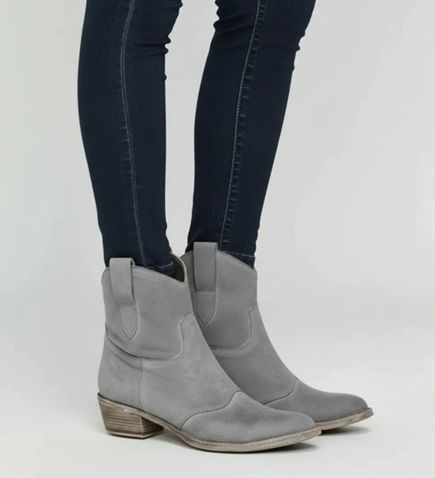 Women's brown western ankle boots with low block heel, slouch design, and easy pull-on style