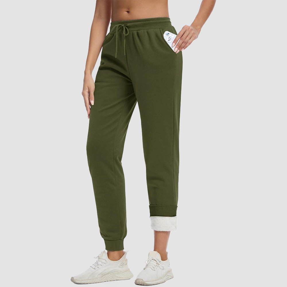 Women's sherpa lined fleece joggers in cozy winter style with deep side pockets for warmth