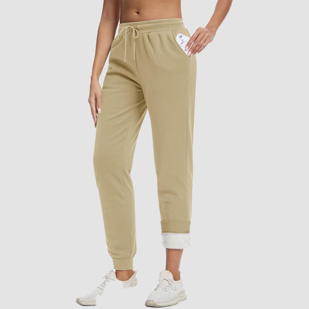 Women's sherpa lined fleece joggers in cozy winter style with deep side pockets for warmth