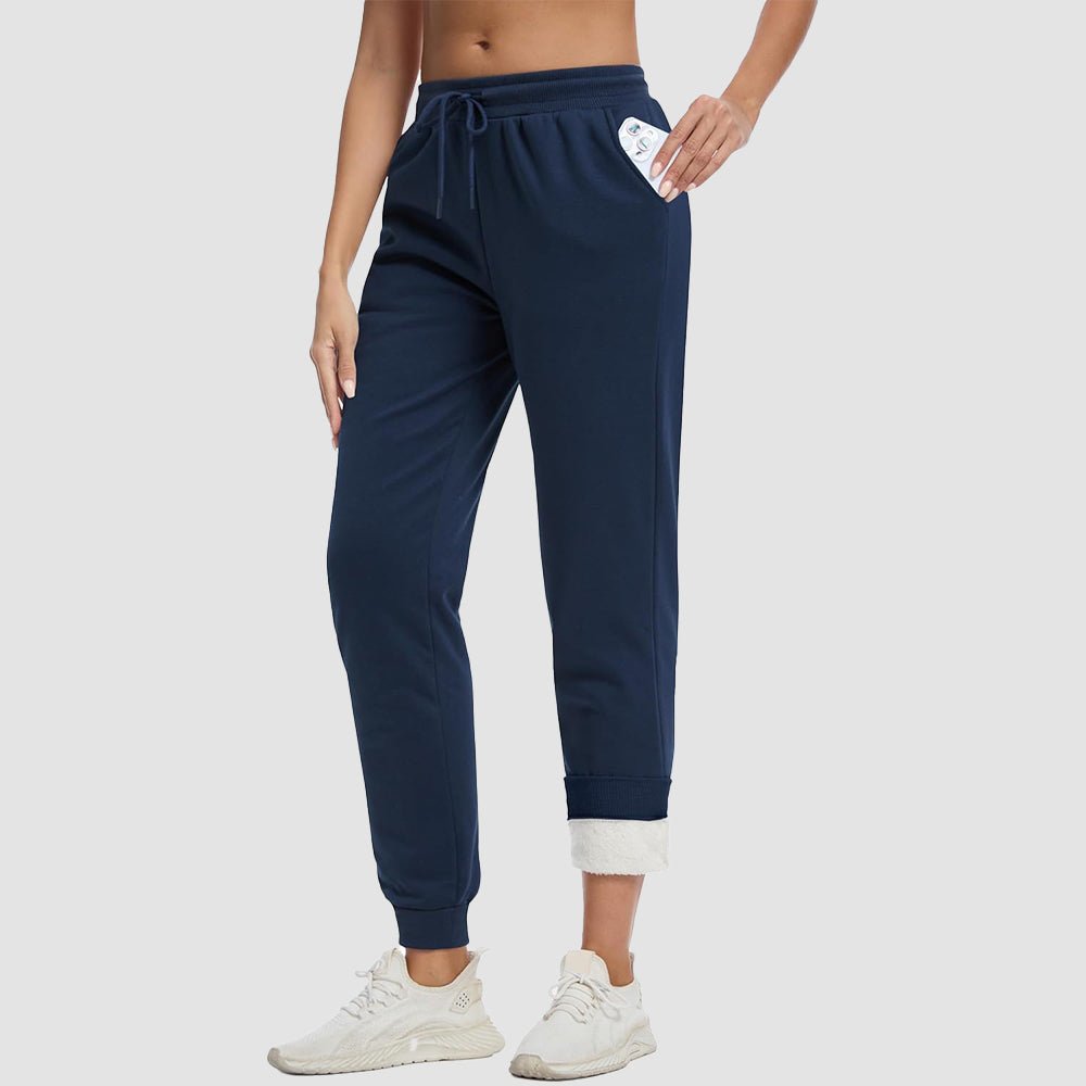 Women's sherpa lined fleece joggers in cozy winter style with deep side pockets
