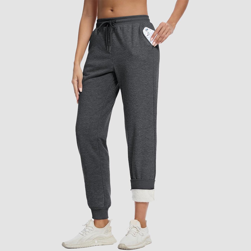 Women's sherpa lined fleece joggers in cozy fit with deep side pockets for winter warmth