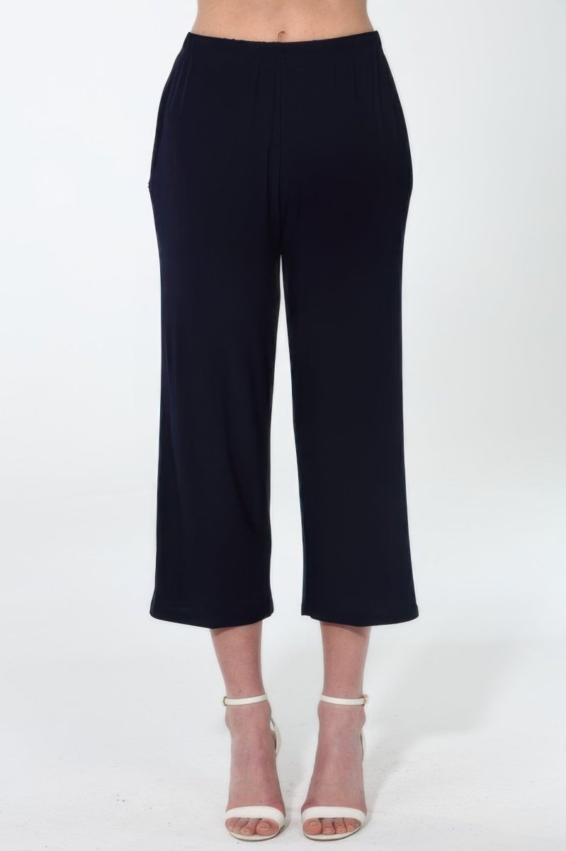 Women's wide leg ankle pants in neutral tone with fluid silhouette and functional side pockets