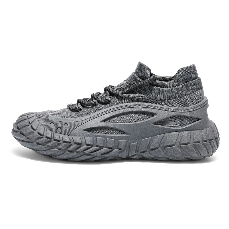 Black urban performance sneaker with tire-grip chunky outsole, breathable exoskeleton, and seamless sock fit
